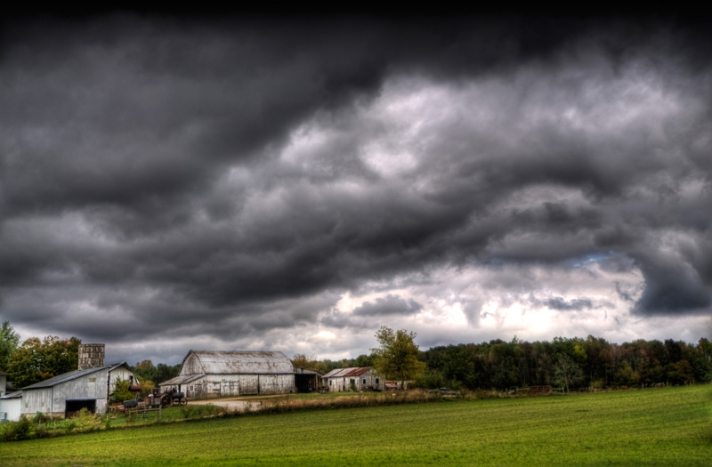 Photo of farm with clouds.